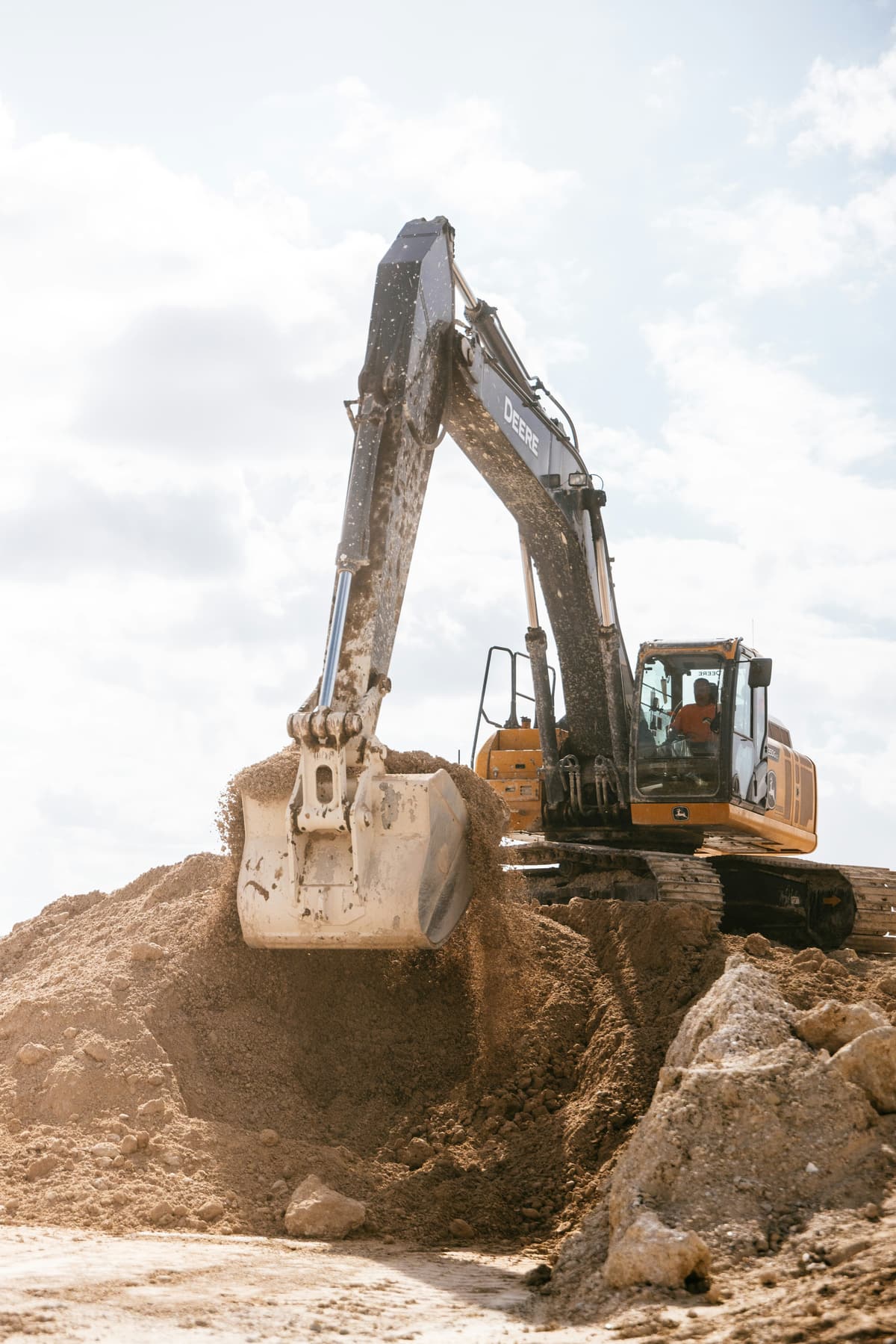 Excavator performing earthworks grading